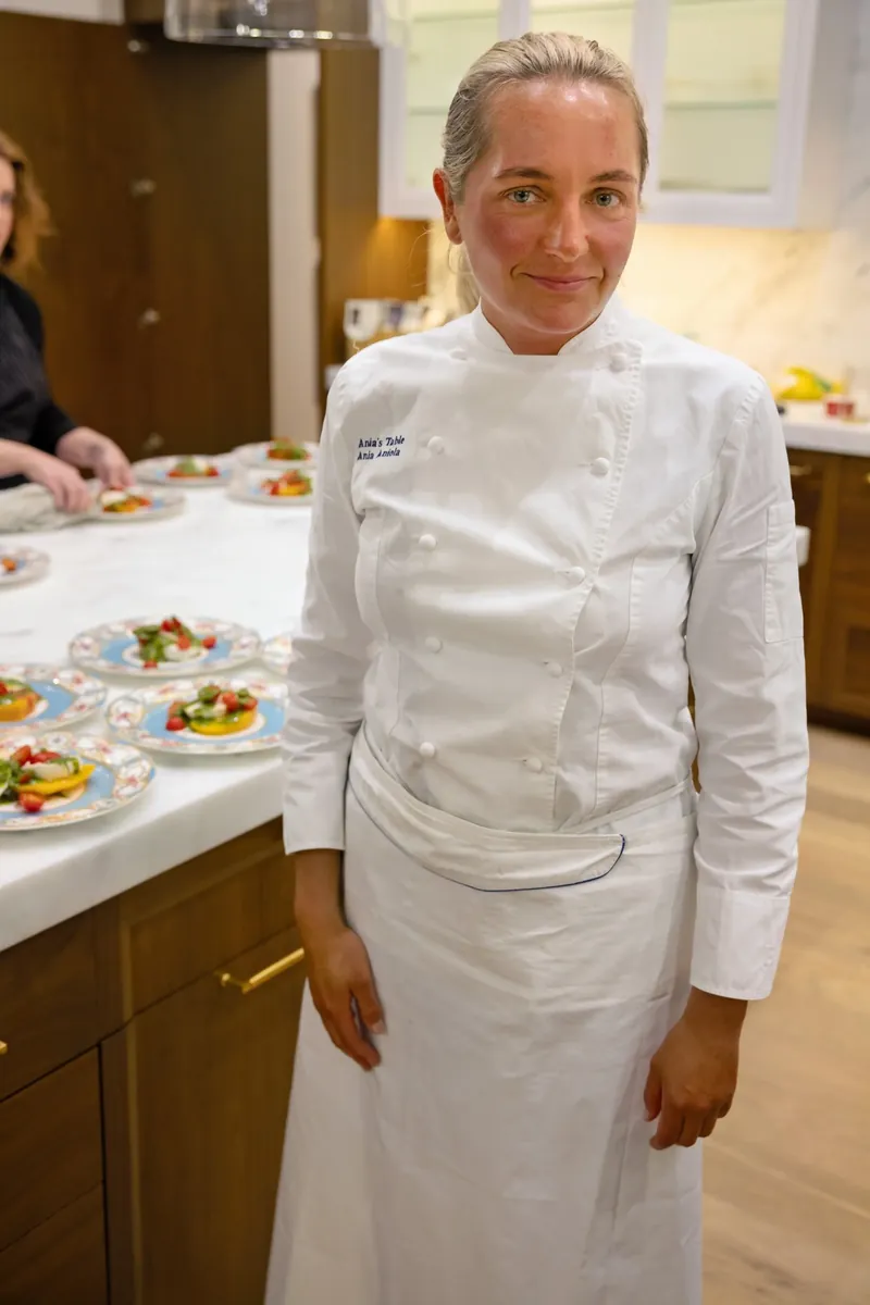 Chef Ania Aniola plating food in a kitchen