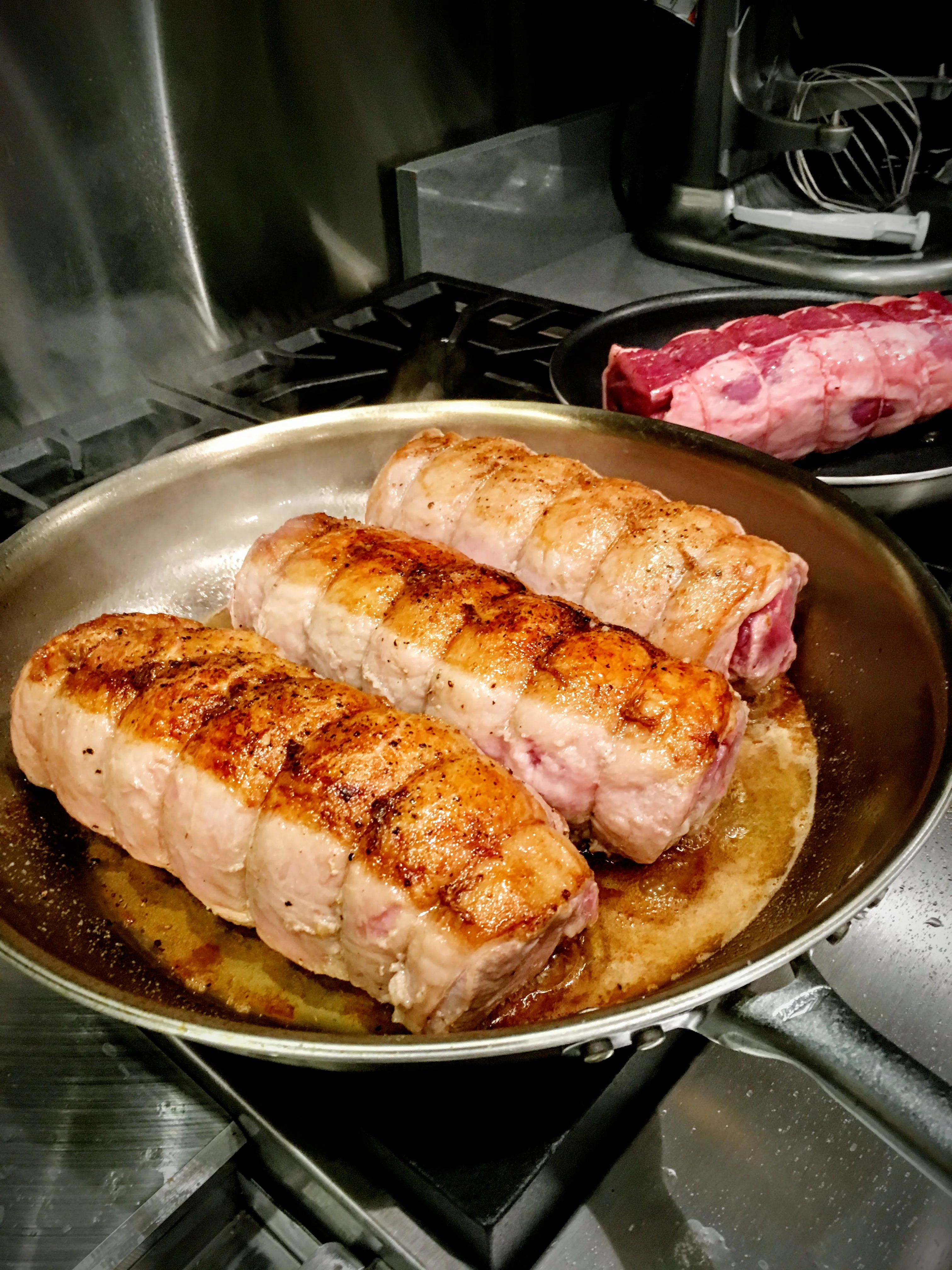 Pan-seared rolled pork loin in a skillet at a Napa Valley private dinner